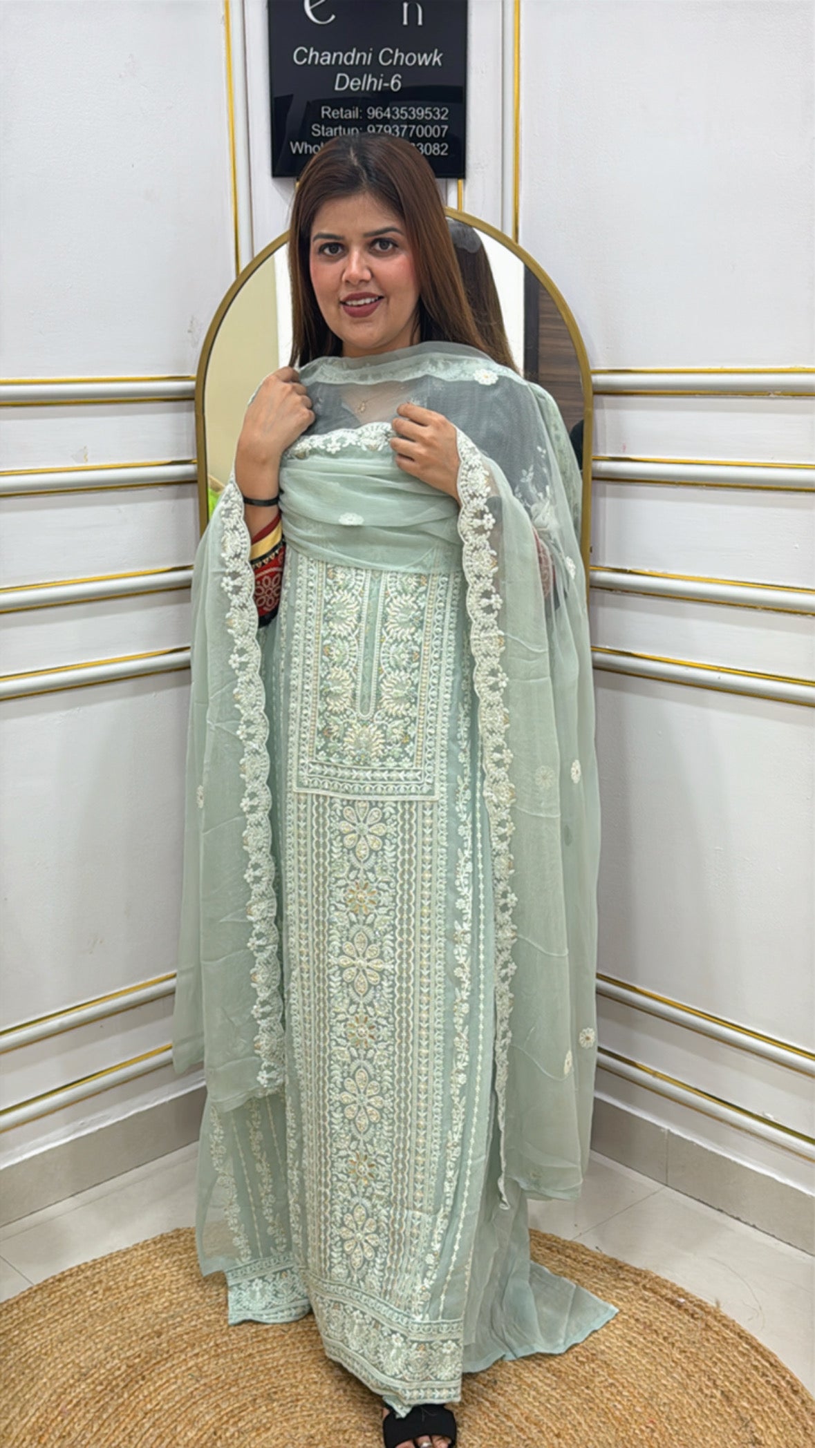 Model wearing a beautiful mint green premium Lucknowi unstitched suit with intricate embroidery and a matching dupatta